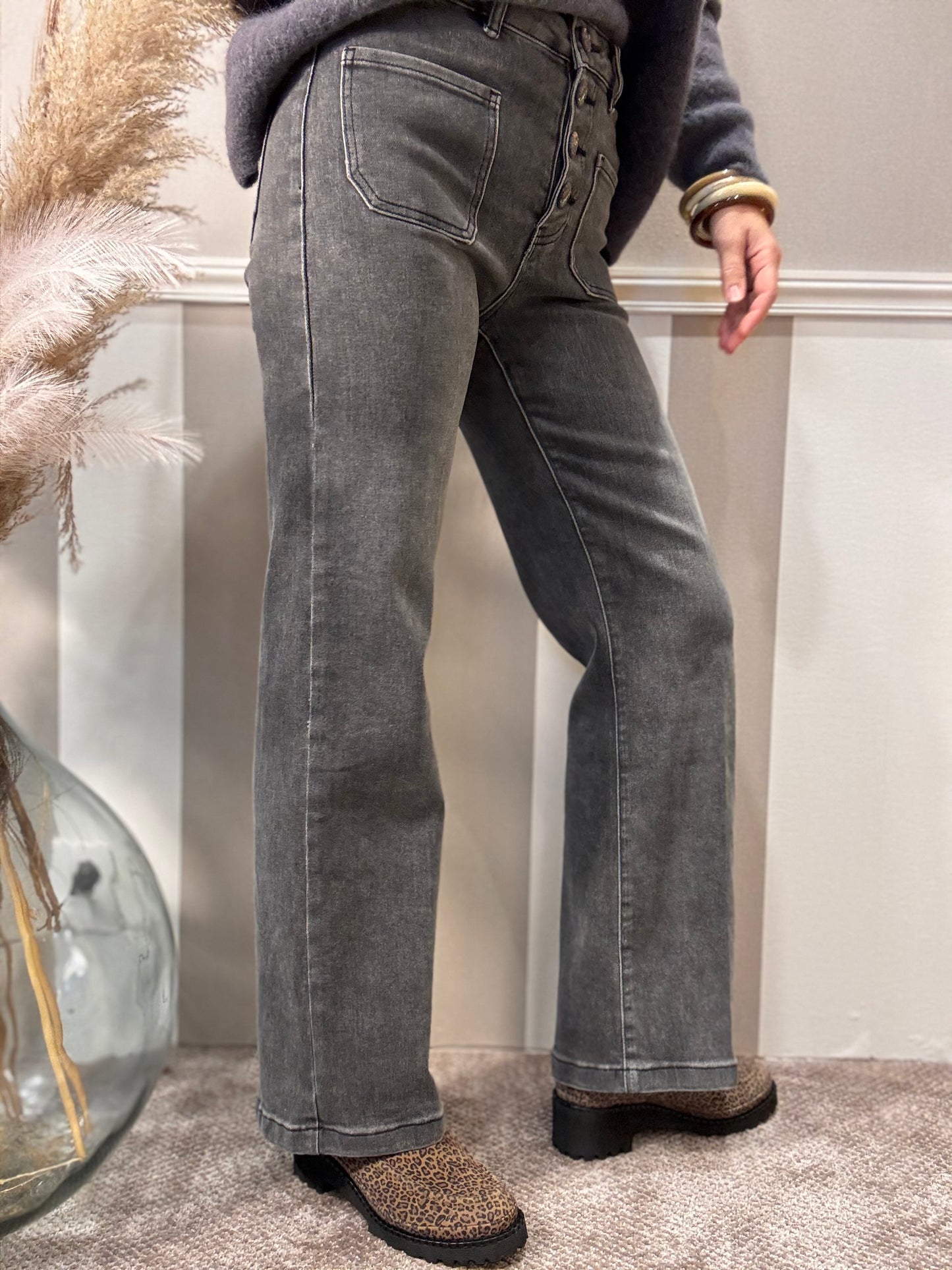 Le jeans délavé à boutons brodés