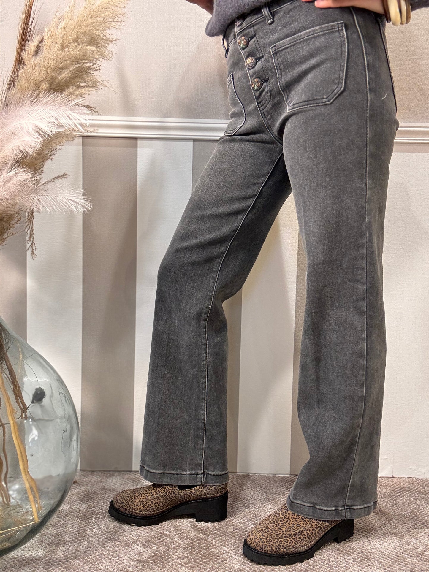 Le jeans délavé à boutons brodés